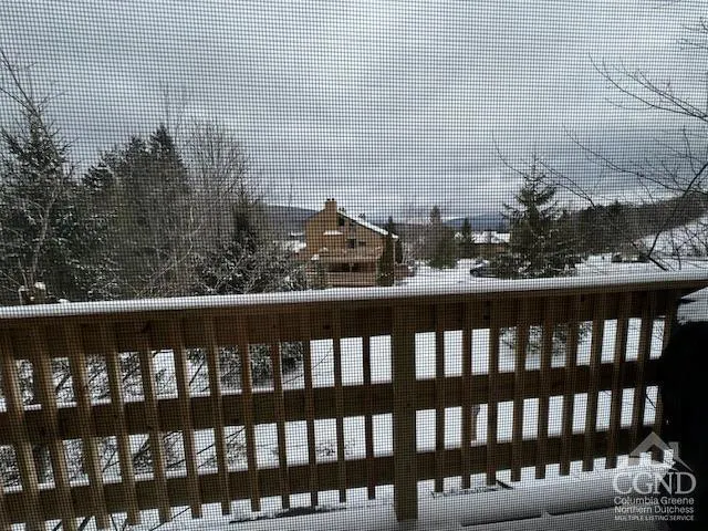 a view of staircase with wooden floor and a rug