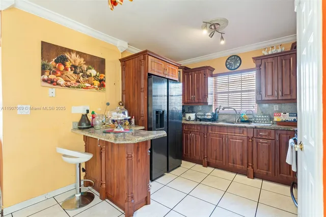 a kitchen with stainless steel appliances granite countertop a stove a sink dishwasher and cabinets with wooden floor