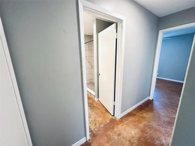 a view of kitchen with stainless steel appliances wooden floor and a refrigerator