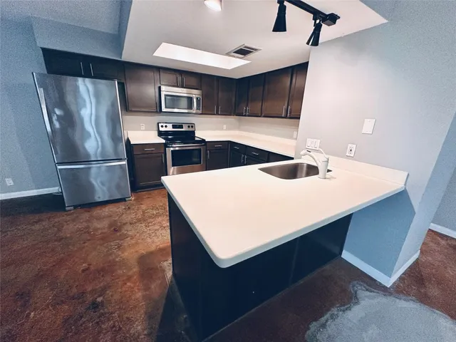 a kitchen with a refrigerator and a sink