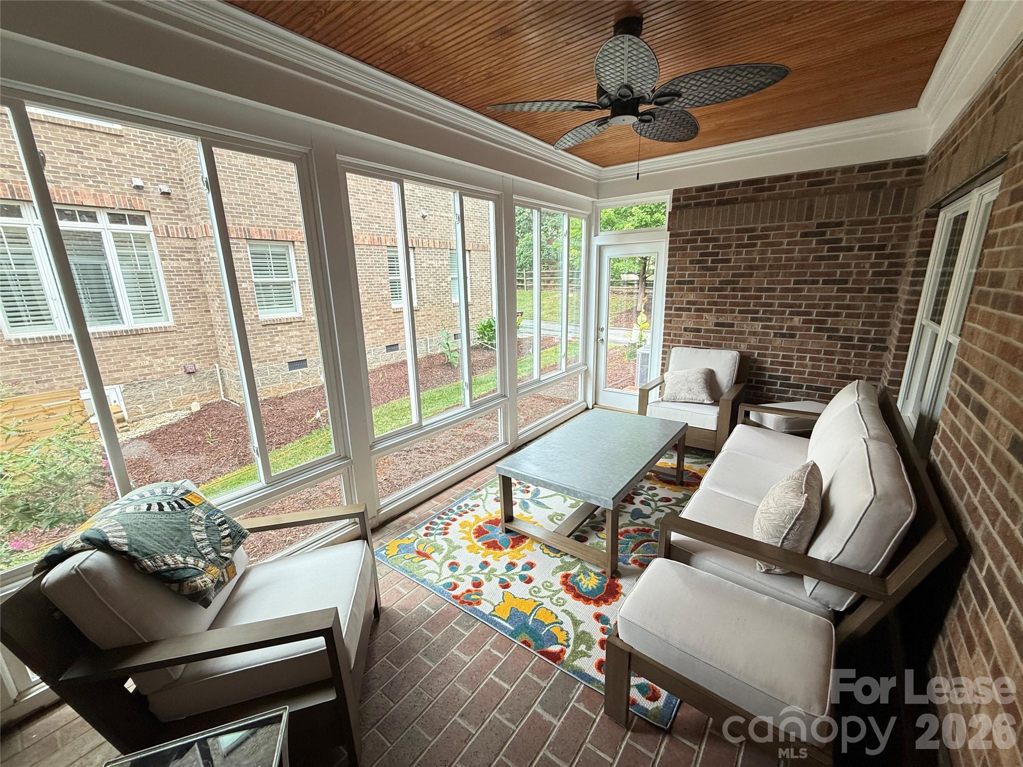 421 Spring Street Davidson, NC 28036 - Photo 8 of 24 a living room with furniture and a floor to ceiling window