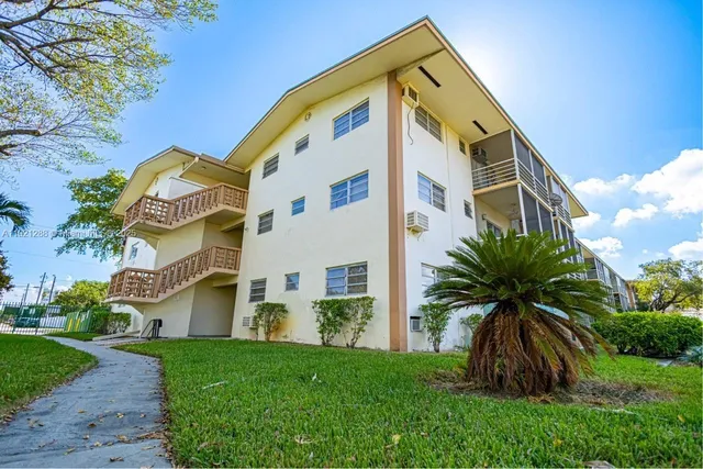 a swimming pool with a lawn chairs and painted walls