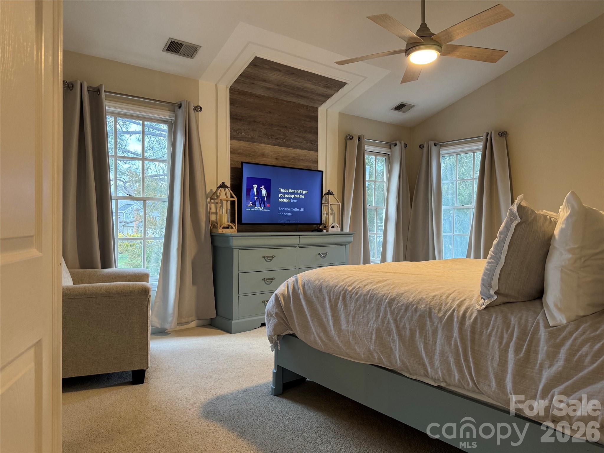 4846 Fortunes Ridge Trail Charlotte, NC 28269 - Photo 22 of 43 a bedroom with a large bed and a chandelier