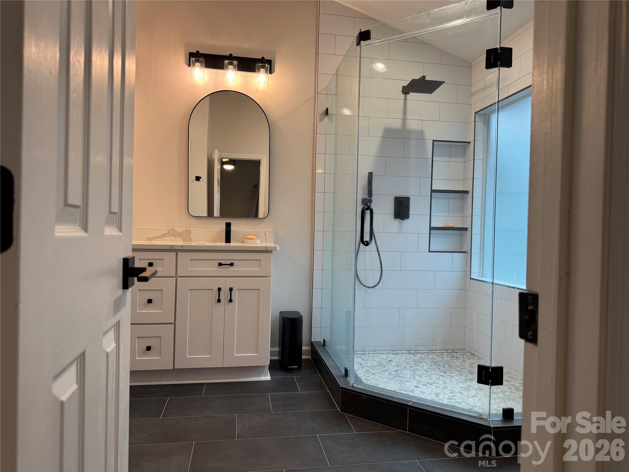 4846 Fortunes Ridge Trail Charlotte, NC 28269 - Photo 25 of 43 a bathroom with a double vanity sink mirror and shower