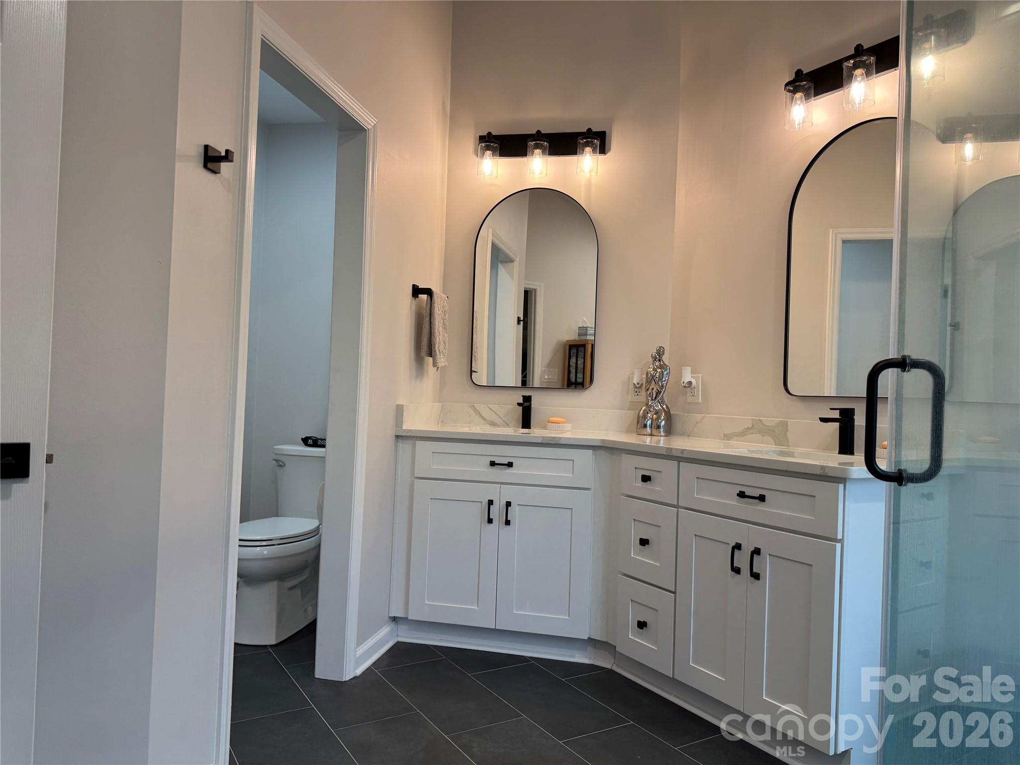 4846 Fortunes Ridge Trail Charlotte, NC 28269 - Photo 26 of 43 a bathroom with a double vanity sink and a toilet