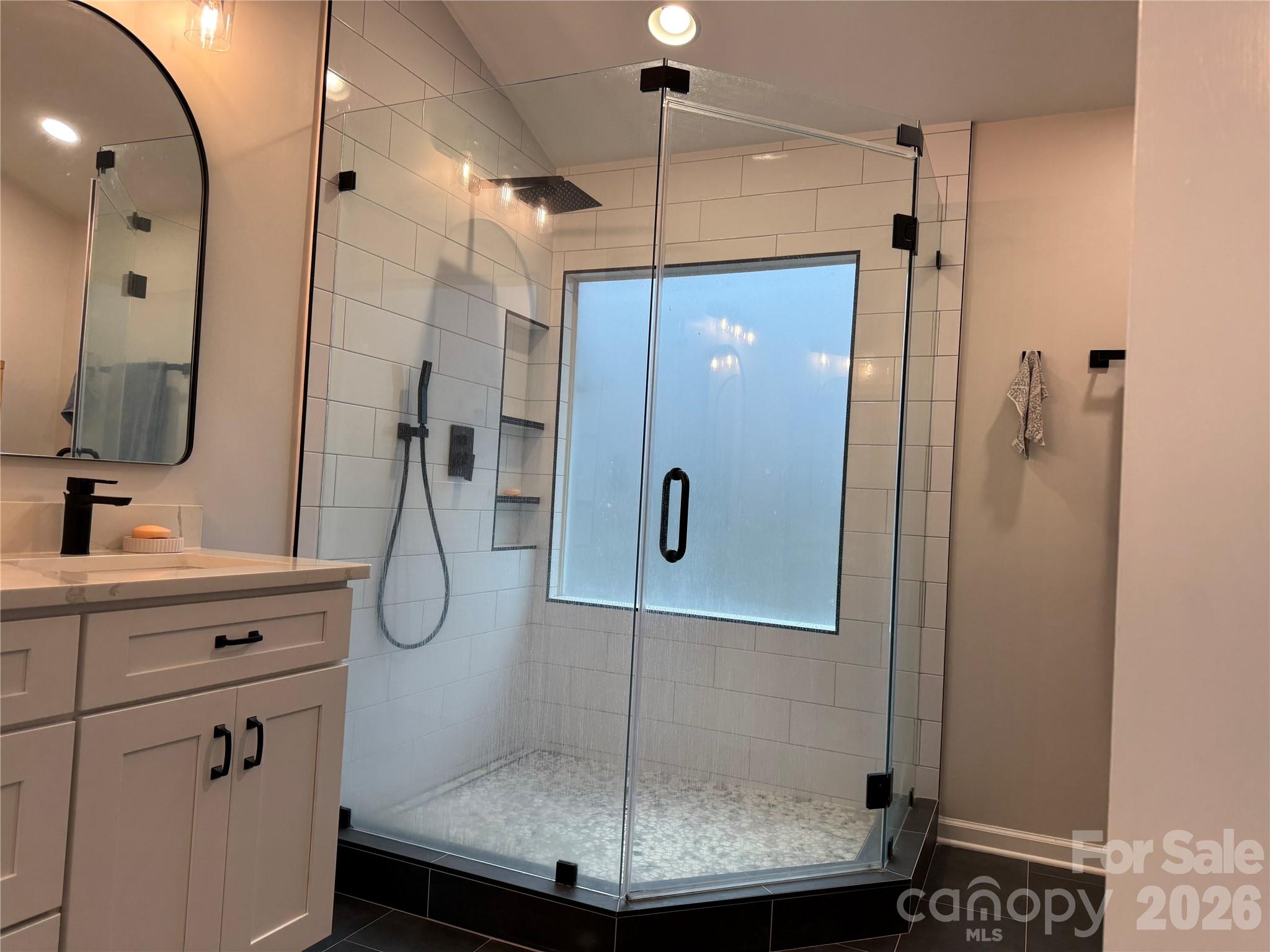 4846 Fortunes Ridge Trail Charlotte, NC 28269 - Photo 27 of 43 a bathroom with a sink shower and mirror