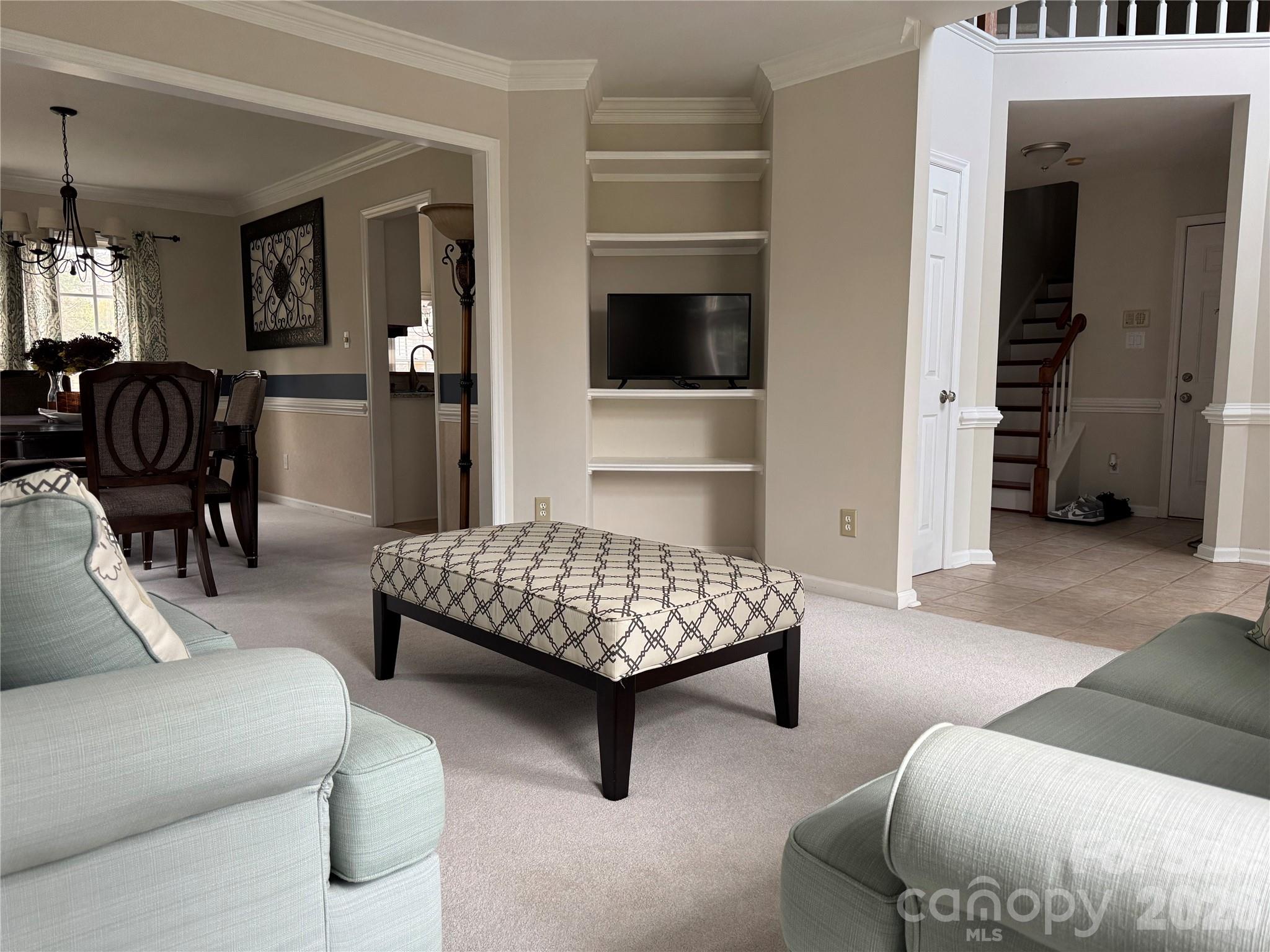4846 Fortunes Ridge Trail Charlotte, NC 28269 - Photo 6 of 43 a living room with furniture and a flat screen tv
