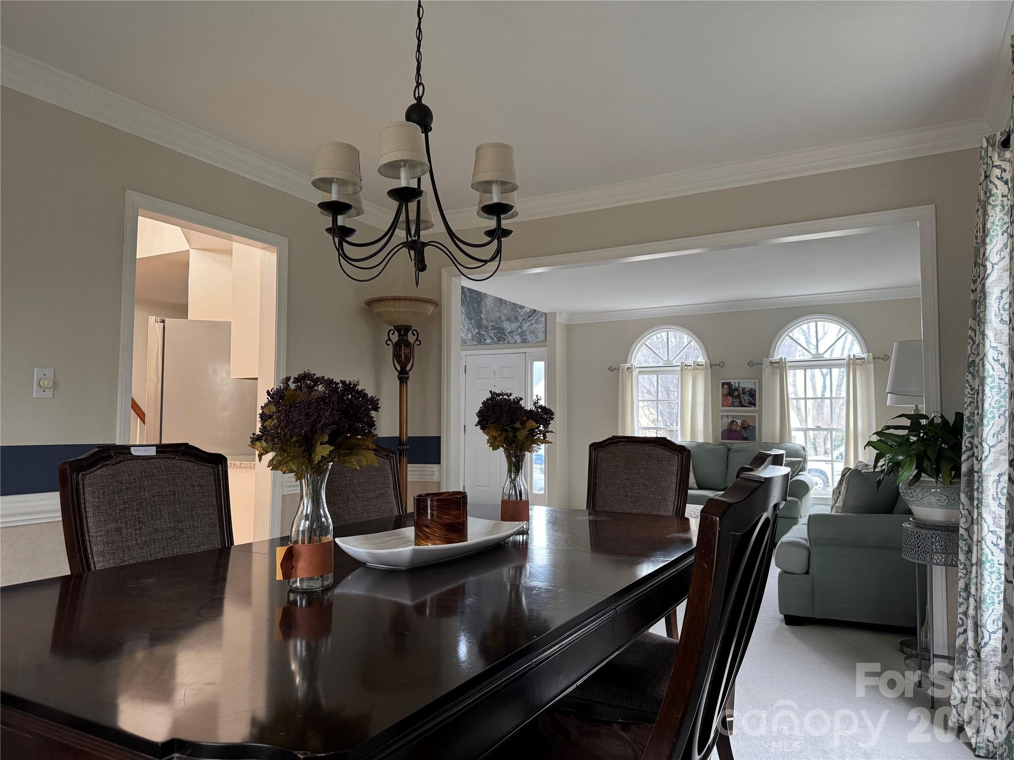 4846 Fortunes Ridge Trail Charlotte, NC 28269 - Photo 7 of 43 a view of a dining room with furniture and a chandelier