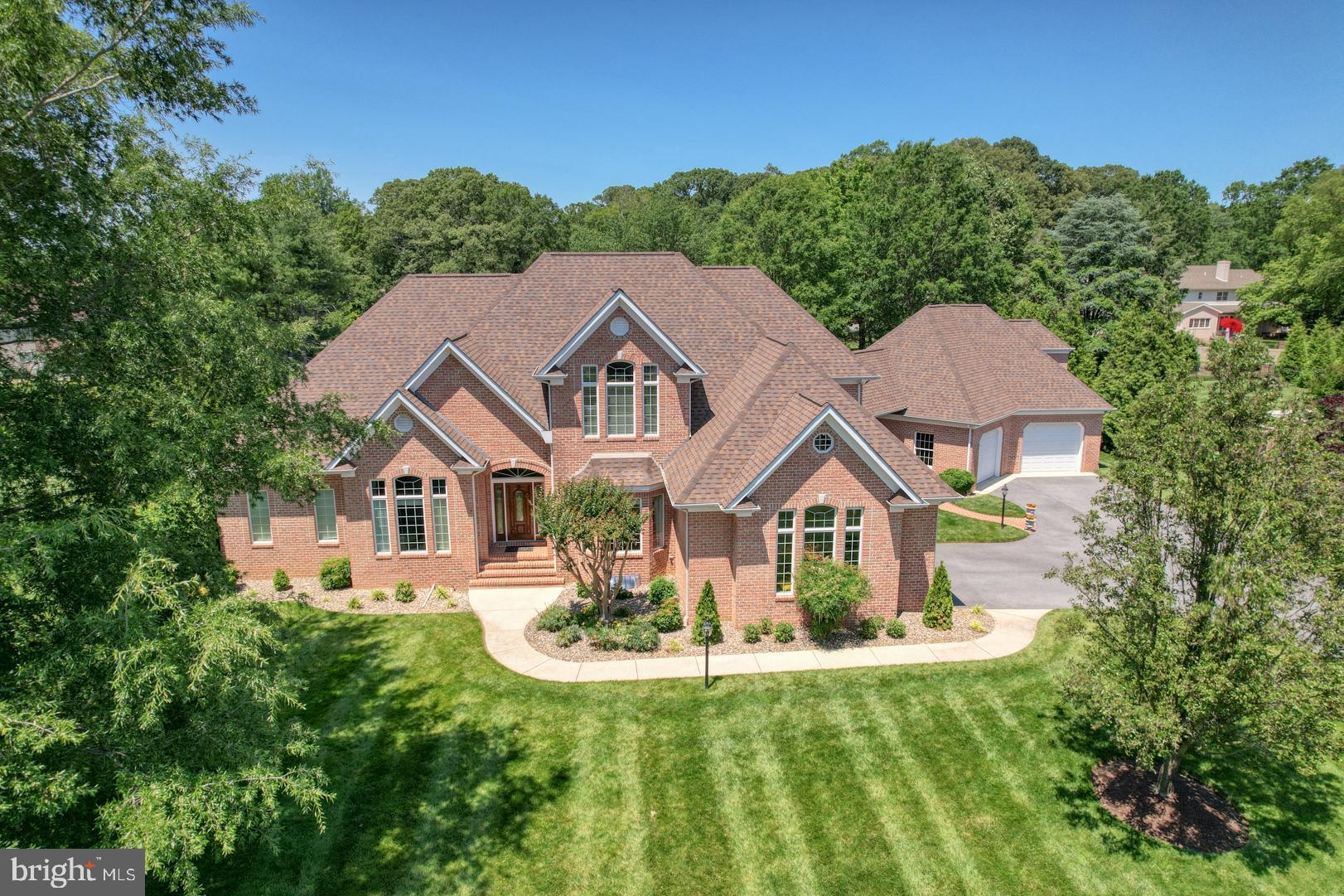 a aerial view of a house with yard and green space