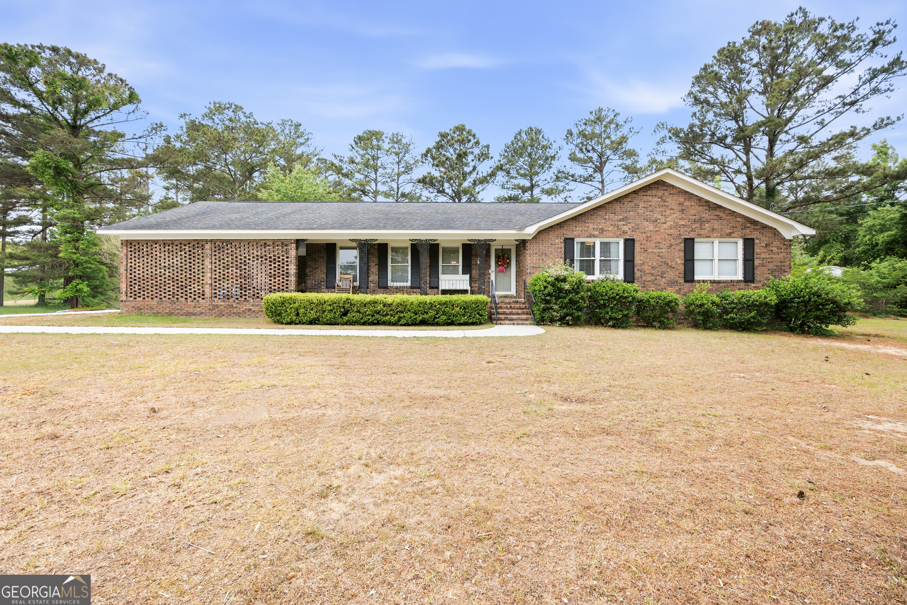 3773 Trophy Place Lizella, GA 31052 - Photo 1 of 32 a front view of a house with a garden