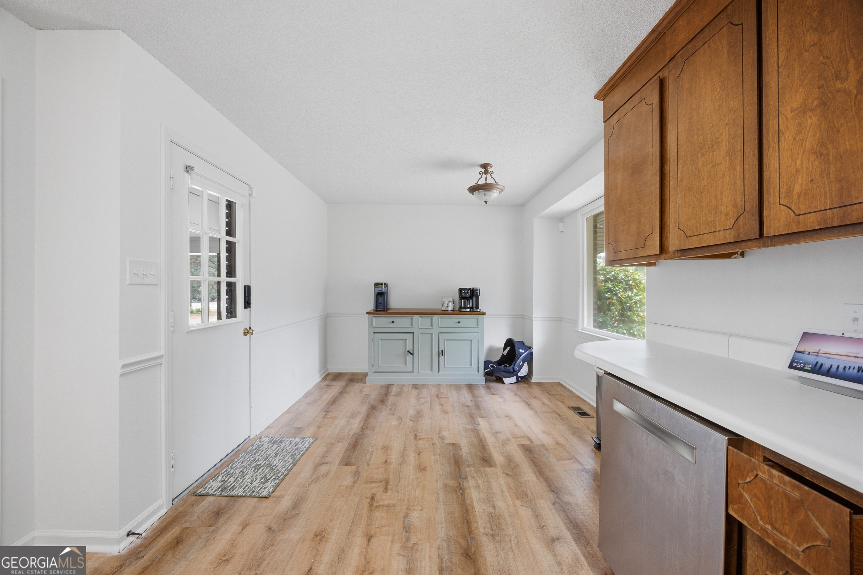 3773 Trophy Place Lizella, GA 31052 - Photo 12 of 32 a view of a kitchen with a sink dishwasher cabinets and wooden floor
