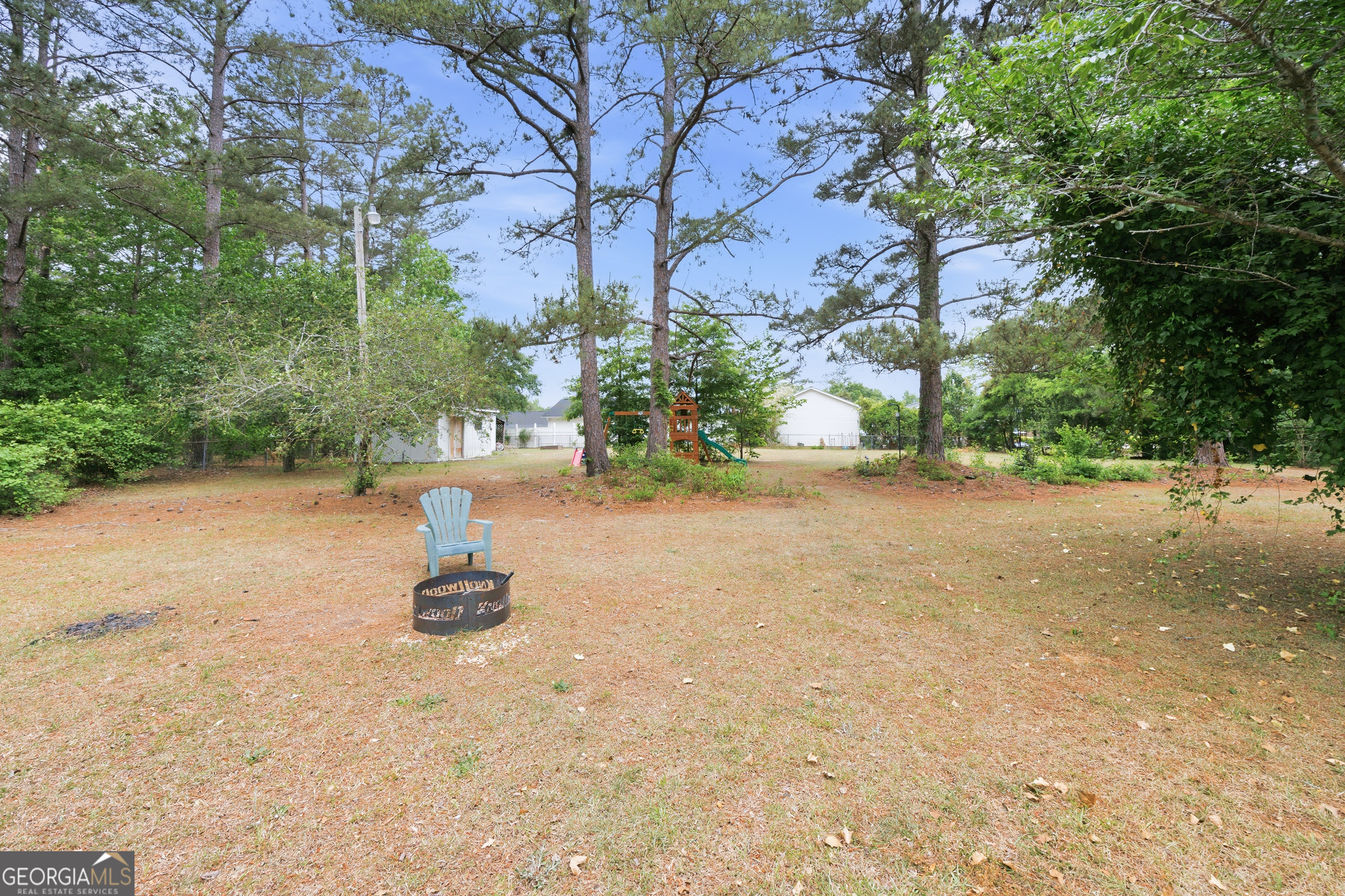 3773 Trophy Place Lizella, GA 31052 - Photo 24 of 32 a view of a fire pit with large trees