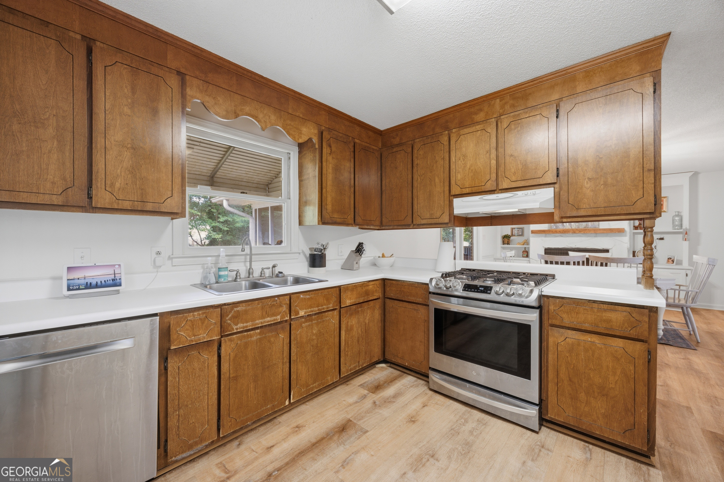 3773 Trophy Place Lizella, GA 31052 - Photo 10 of 32 a kitchen with stainless steel appliances granite countertop a sink stove and cabinets