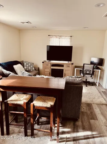 a living room with furniture a flat screen tv and a fireplace
