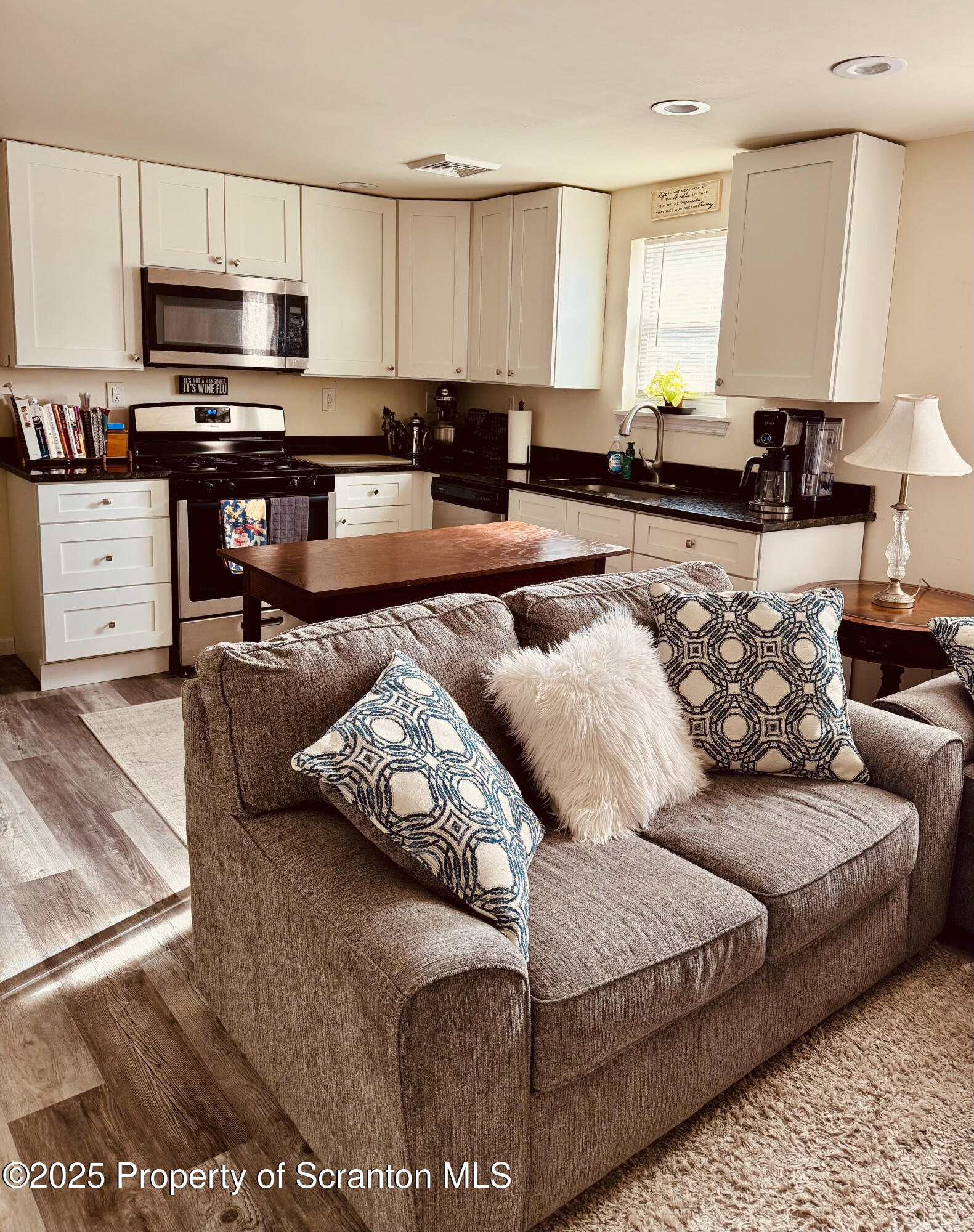 200 Dunmore Street, Unit 3 Throop, PA 18512 - Photo 3 of 9 a living room with furniture and kitchen