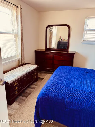 a bedroom with two beds and painting on the wall