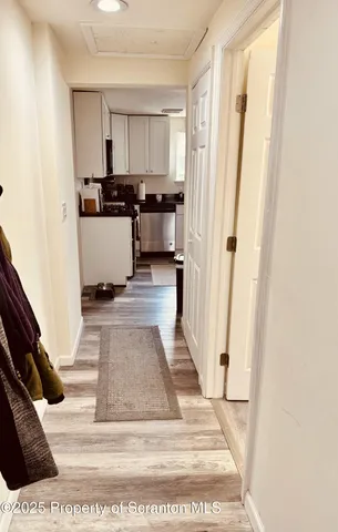 a view of kitchen with sink and refrigerator