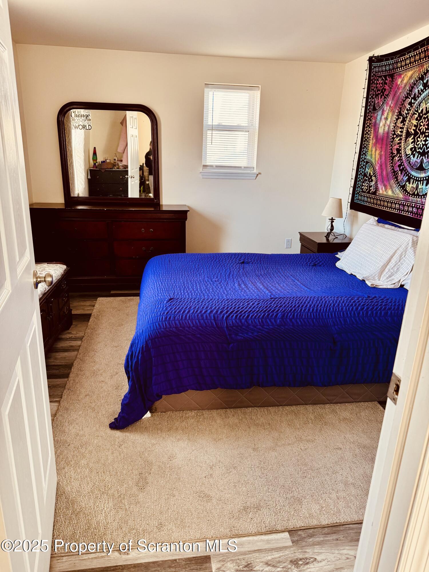 200 Dunmore Street, Unit 3 Throop, PA 18512 - Photo 8 of 9 a bedroom with a bed and painting on the wall