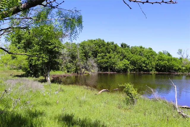 a view of a lake with houses in the back