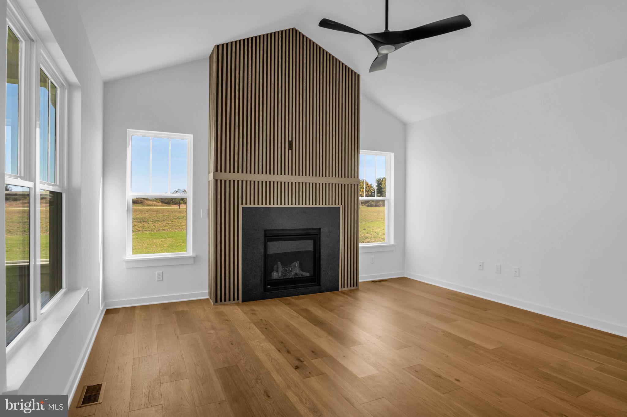 117 Bellflower Avenue Lebanon, PA 17042 - Photo 6 of 12 a view of empty room with wooden floor and fireplace