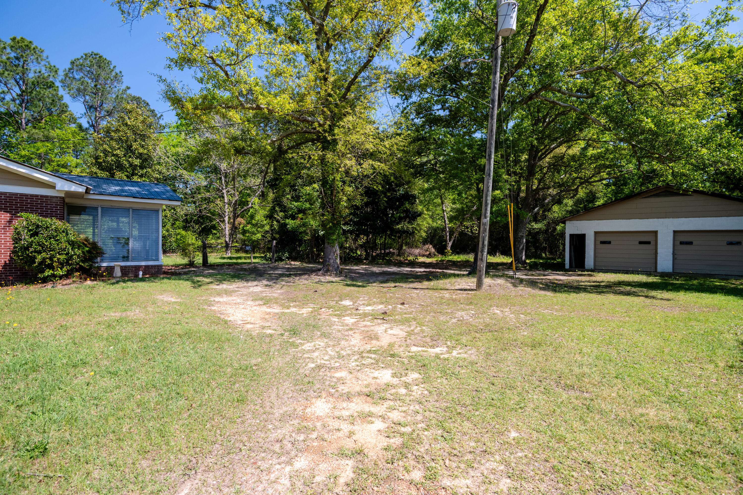 39 Gantt Street Wagener, SC 29164 - Photo 25 of 30 a front view of house with yard and trees in the background