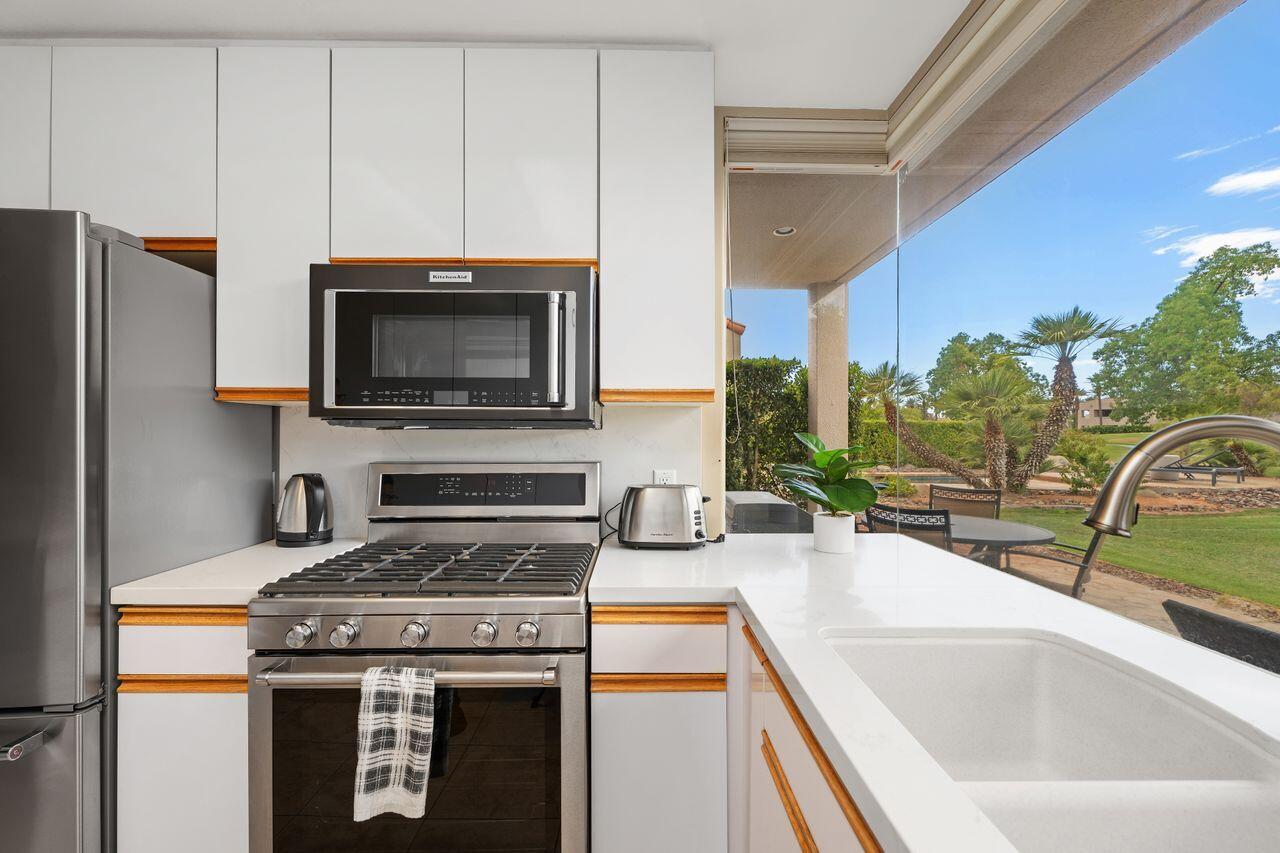 20 Pebble Beach Drive Rancho Mirage, CA 92270 - Photo 17 of 41 a kitchen with a stove and a microwave
