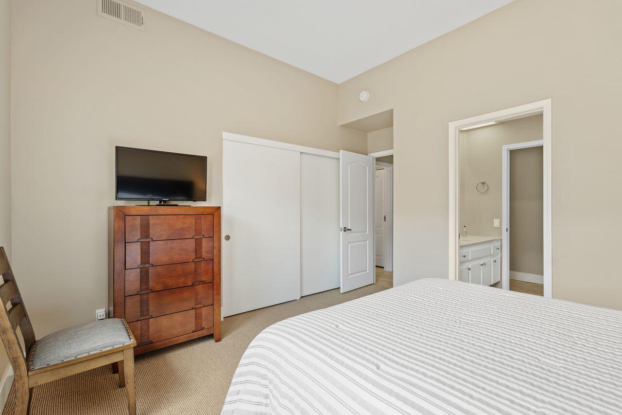 20 Pebble Beach Drive Rancho Mirage, CA 92270 - Photo 19 of 41 a bedroom with a bed and a television