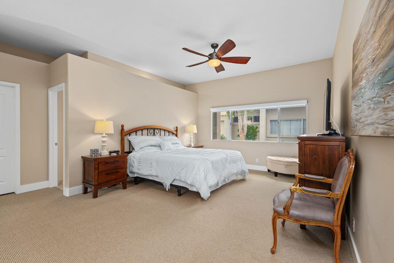 20 Pebble Beach Drive Rancho Mirage, CA 92270 - Photo 22 of 41 a bedroom with a bed wooden floor and window
