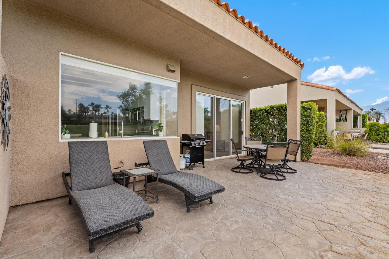 20 Pebble Beach Drive Rancho Mirage, CA 92270 - Photo 27 of 41 a living room with patio furniture and a large window