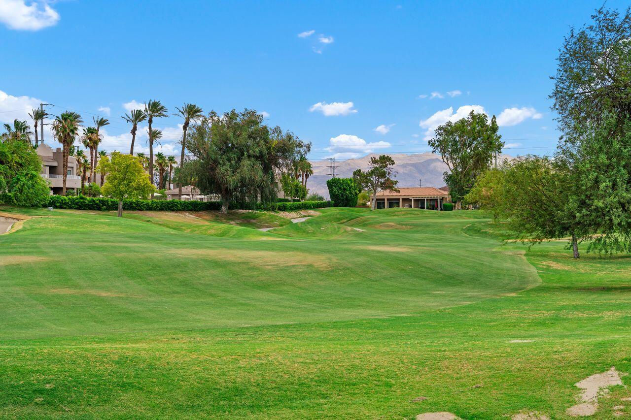 20 Pebble Beach Drive Rancho Mirage, CA 92270 - Photo 32 of 41 a backyard of a house with lots of green space and outdoor seating