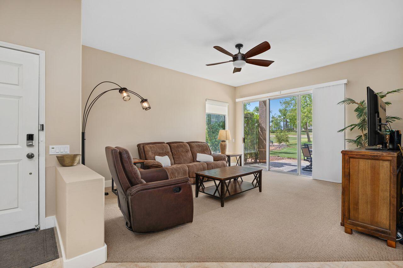 20 Pebble Beach Drive Rancho Mirage, CA 92270 - Photo 10 of 41 a living room with furniture a ceiling fan and a window