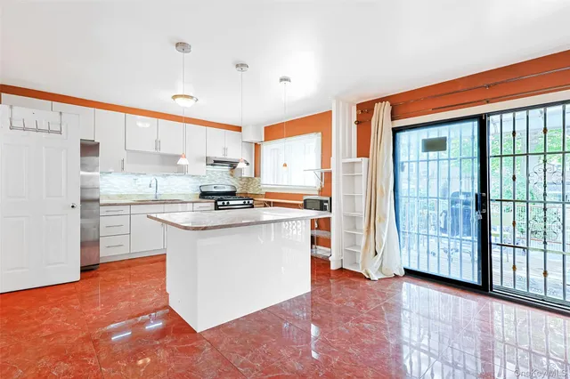 a kitchen with stainless steel appliances granite countertop a refrigerator and a stove top oven
