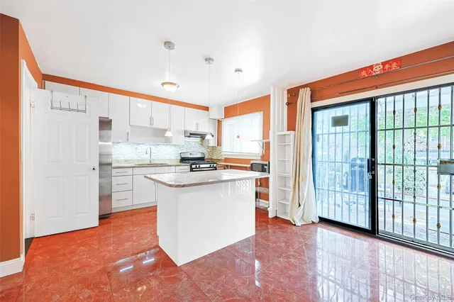 a kitchen with stainless steel appliances granite countertop a stove a sink and a refrigerator
