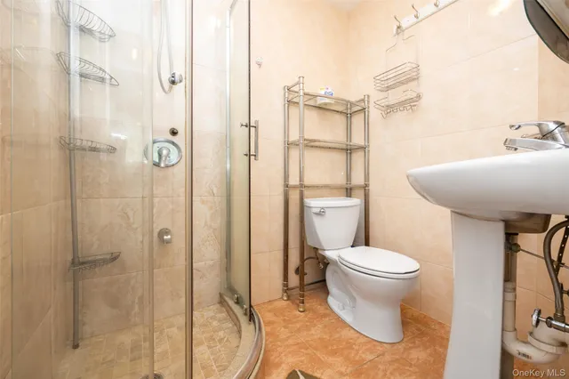 a bathroom with a toilet a sink and a shower