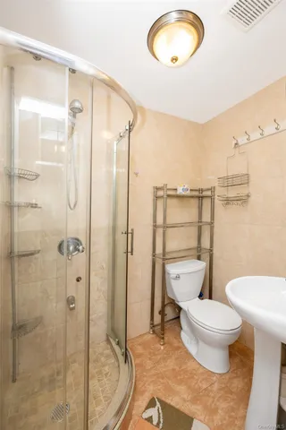 a view of a big room with wooden floor and windows