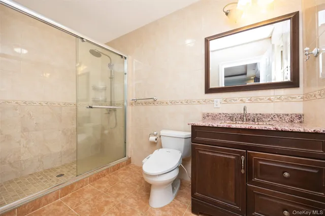 a view of a livingroom with wooden floor and a kitchen