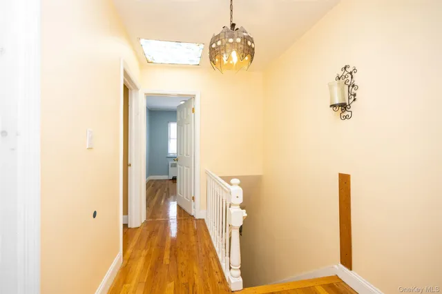 a view of a room with wooden floor and windows