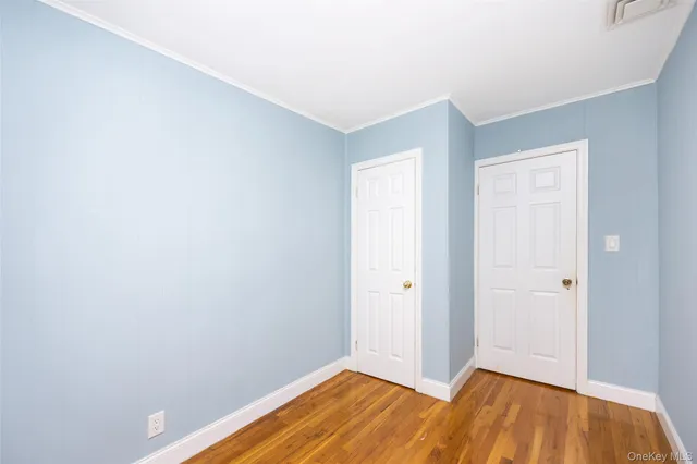 a view of a room with wooden floor and entrance