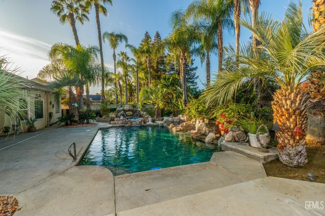 a view of backyard with outdoor seating and trees