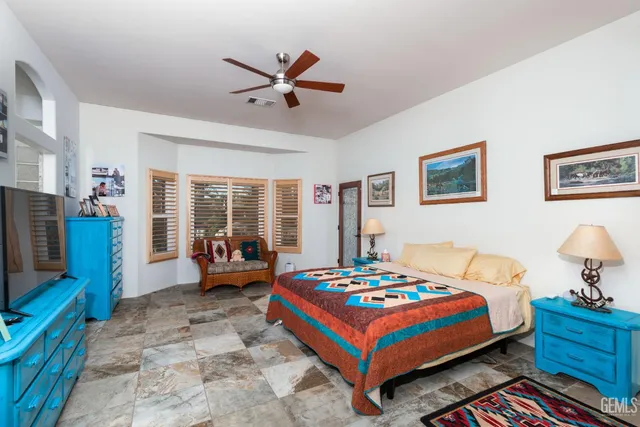 a bedroom with a bed and wall painting