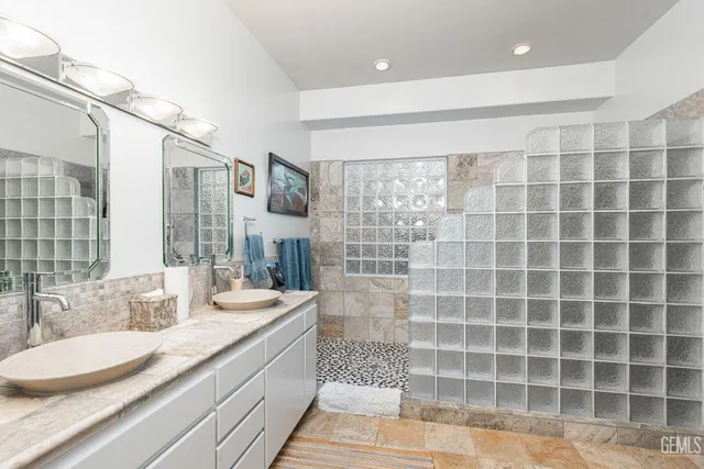 a bathroom with sinks mirror and vanity