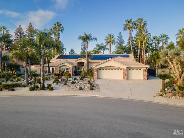 a front view of a house with a garden and patio