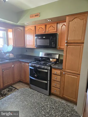 a kitchen with stainless steel appliances and cabinets