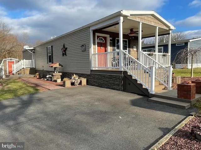 a front view of a house with parking area
