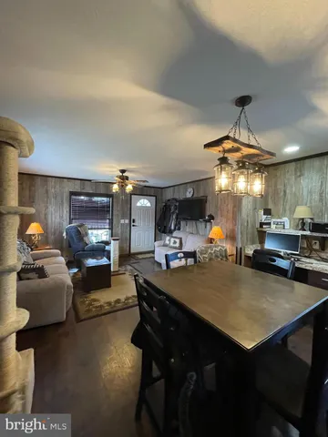 a view of a dining room with furniture and chandelier