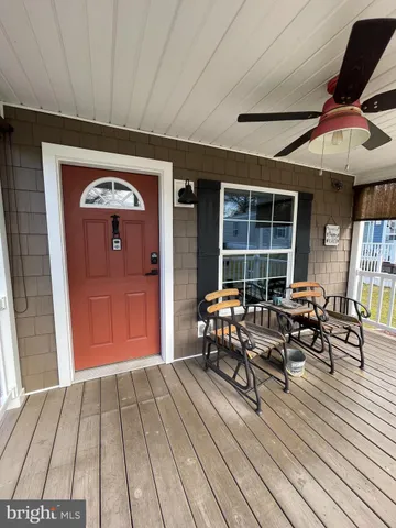 a balcony with furniture and a potted plant
