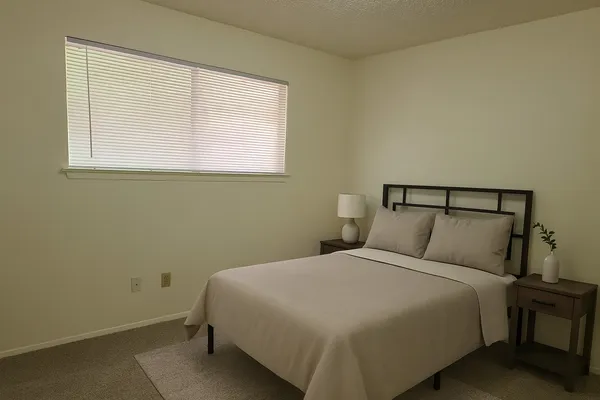 a bedroom with a bed and window