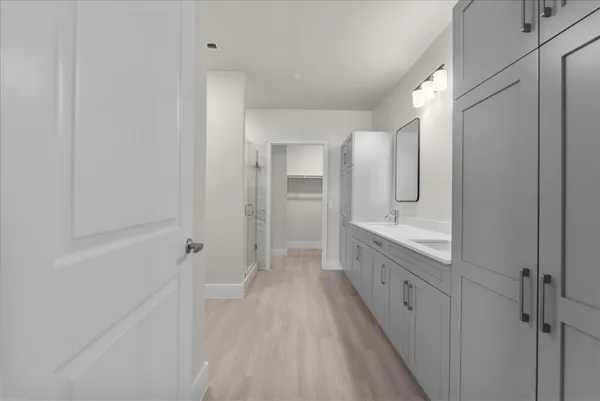a spacious bathroom with a double vanity sink and a mirror