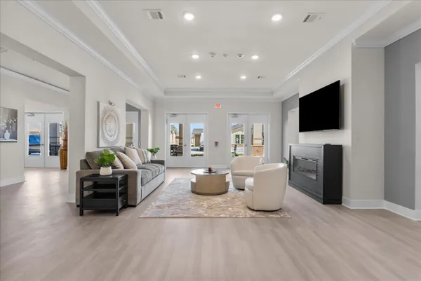 a living room with furniture a flat screen tv and a fireplace
