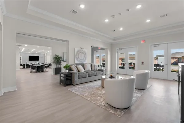 a living room with furniture and view of kitchen